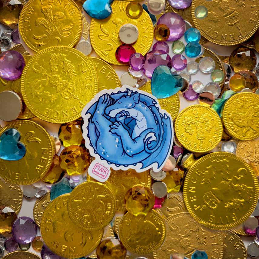 Gold coins and colorful gemstones with a sticker featuring a sleeping blue dragon.