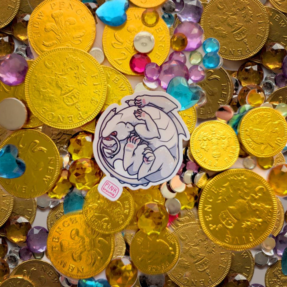 Gold coins and colorful gemstones with a sticker featuring a sleeping white dragon.